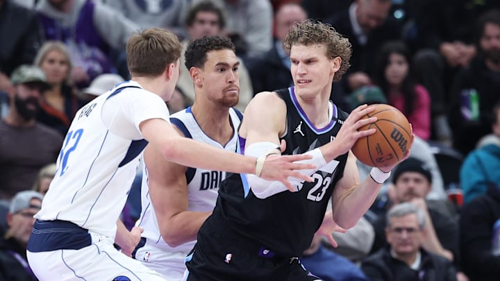 Dec 15, 2025; Salt Lake City, Utah, USA; Utah Jazz forward Lauri Markkanen (23) prepares to shoot against Dallas Mavericks forward Dwight Powell (7) and forward Cooper Flagg (32) during the first quarter at Delta Center. Mandatory Credit: Rob Gray-Imagn Images