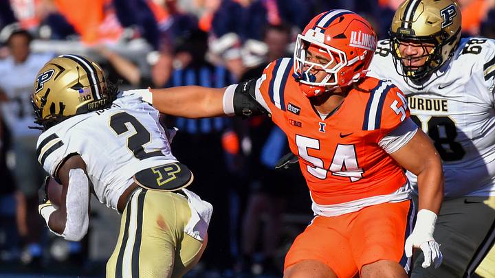 Oct 3, 2026; Champaign, Illinois, USA; Illinois Fighting Illini defensive lineman Demetrius John (54) tries to get a hand on Purdue Boilermakers running back Fame Ijeboi (2) during the first half at Gies Memorial Stadium. Mandatory Credit: Ron Johnson-Imagn Images Oct 3, 2026; Champaign, Illinois, USA; Illinois Fighting Illini defensive lineman Demetrius John (54) tries to get a hand on Purdue Boilermakers running back Fame Ijeboi (2) during the first half at Gies Memorial Stadium. Mandatory Credit: Ron Johnson-Imagn Images