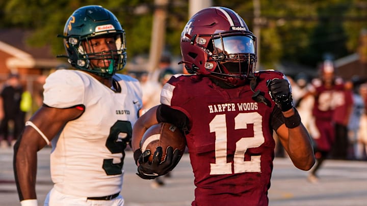 Harper Woods wide receiver Tyler Buford runs for a first down against Birmingham Groves during the first half at Harper Woods High School in Harper Woods on Friday, Sept. 12, 2025.