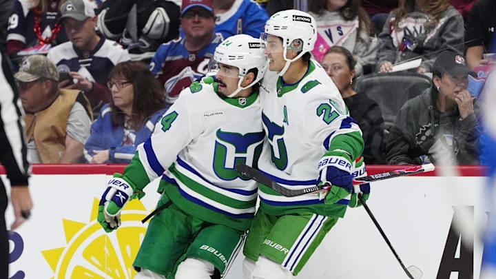 Oct 23, 2025; Denver, Colorado, USA; Carolina Hurricanes center Seth Jarvis (24) celebrates his goal with defenseman Mike Reilly (6) and center Sebastian Aho (20) in the first period against the Colorado Avalanche at Ball Arena. Mandatory Credit: Ron Chenoy-Imagn Images