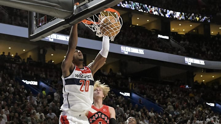 Oct 6, 2024; Montreal, Quebec, CAN; Washington Wizards power forward Alex Sarr (20) dunks over Toronto Raptors guard Gradey Dick (1) during the second quarter at the Bell Centre. Mandatory Credit: Eric Bolte-Imagn Images