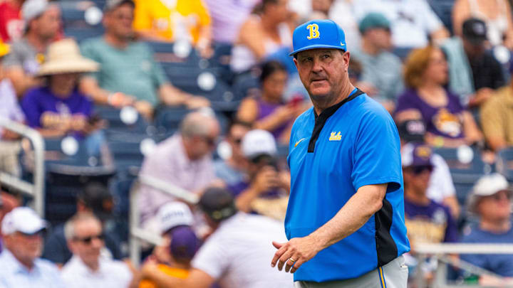 Jun 16, 2025; Omaha, Neb, USA; UCLA Bruins head coach John Savage walks off the field before the game against the LSU Tigers at Charles Schwab Field. Mandatory Credit: Dylan Widger-Imagn Images