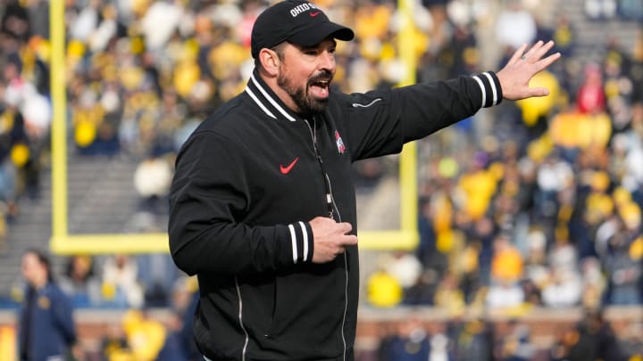 Ohio State coach Ryan Day leads his team in warmups prior to their game against Michigan at Michigan Stadium.