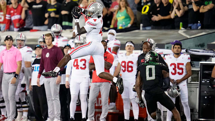Oct 12, 2024; Eugene, Oregon, USA; Ohio State Buckeyes wide receiver Jeremiah Smith (4) makes a catch against Oregon Ducks defensive back Tysheem Johnson (0) in the second half during the NCAA football game at Autzen Stadium. Oct 12, 2024; Eugene, Oregon, USA; Ohio State Buckeyes wide receiver Jeremiah Smith (4) makes a catch against Oregon Ducks defensive back Tysheem Johnson (0) in the second half during the NCAA football game at Autzen Stadium.