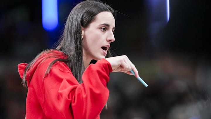 Indiana Fever guard Caitlin Clark (22) talks with an official during a timeout at a game between the Indiana Fever and the Washington Mystics at Gainbridge Fieldhouse in Indianapolis.