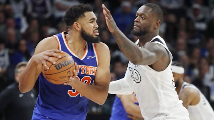 Dec 19, 2024; Minneapolis, Minnesota, USA; New York Knicks forward Karl-Anthony Towns (32) works around Minnesota Timberwolves forward Julius Randle (30) in the third quarter at Target Center. Mandatory Credit: Bruce Kluckhohn-Imagn Images