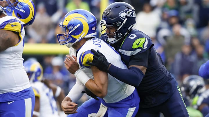 Nov 3, 2024; Seattle, Washington, USA; Seattle Seahawks linebacker Tyrel Dodson (0) pressures Los Angeles Rams quarterback Matthew Stafford (9) during the third quarter at Lumen Field.