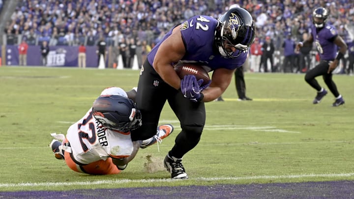 Nov 3, 2024; Baltimore, Maryland, USA; Baltimore Ravens fullback Patrick Ricard (42) dives through Denver Broncos linebacker Kwon Alexander (12) tackle attempt for a touchdown during the second half at M&T Bank Stadium. Mandatory Credit: Tommy Gilligan-Imagn Images Nov 3, 2024; Baltimore, Maryland, USA; Baltimore Ravens fullback Patrick Ricard (42) dives through Denver Broncos linebacker Kwon Alexander (12) tackle attempt for a touchdown during the second half at M&T Bank Stadium. Mandatory Credit: Tommy Gilligan-Imagn Images