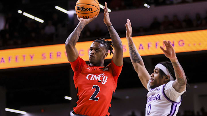 Mar 5, 2025; Cincinnati, Ohio, USA; Cincinnati Bearcats guard Jizzle James (2) shoots against Kansas State Wildcats guard Dug McDaniel (0) in the first half at Fifth Third Arena. Mandatory Credit: Katie Stratman-Imagn Images