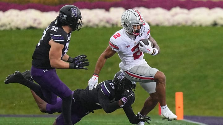 Nov 5, 2022; Evanston, Illinois, USA; Ohio State Buckeyes wide receiver Emeka Egbuka (2) is forced out of bounds by Northwestern Wildcats defensive back Devin Turner (23) and linebacker Bryce Gallagher (32) during the first half of the NCAA football game at Ryan Field. Mandatory Credit: Adam Cairns-The Columbus Dispatch

Ncaa Football Ohio State Buckeyes At Northwestern Wildcats