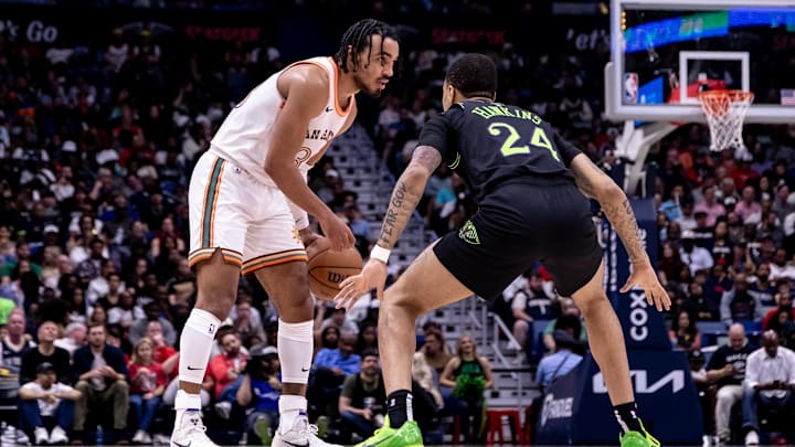 Apr 5, 2024; New Orleans, Louisiana, USA; San Antonio Spurs guard Tre Jones (33) dribbles against New Orleans Pelicans guard Jordan Hawkins (24) during the second half at Smoothie King Center. Apr 5, 2024; New Orleans, Louisiana, USA; San Antonio Spurs guard Tre Jones (33) dribbles against New Orleans Pelicans guard Jordan Hawkins (24) during the second half at Smoothie King Center.