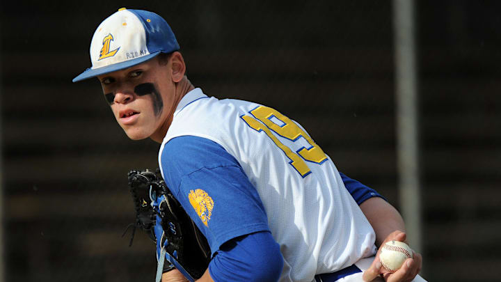 Linden High School pitcher Aaron Judge looks back a Central Catholic runner in 2010.