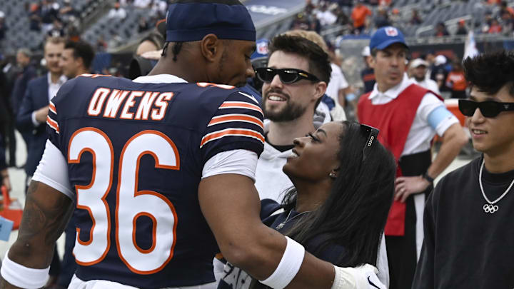 Sep 29, 2024; Chicago, Illinois, USA;  Chicago Bears safety Jonathan Owens (36) and his wife olympian Simone Biles before the game against the Los Angeles Rams at Soldier Field. 