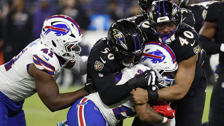 Sep 29, 2024; Baltimore, Maryland, USA; Buffalo Bills running back Ray Davis (22) is tackled by Baltimore Ravens linebacker Adisa Isaac (50) and Ravens linebacker Malik Harrison (40) at M&T Bank Stadium. Mandatory Credit: Geoff Burke-Imagn Images