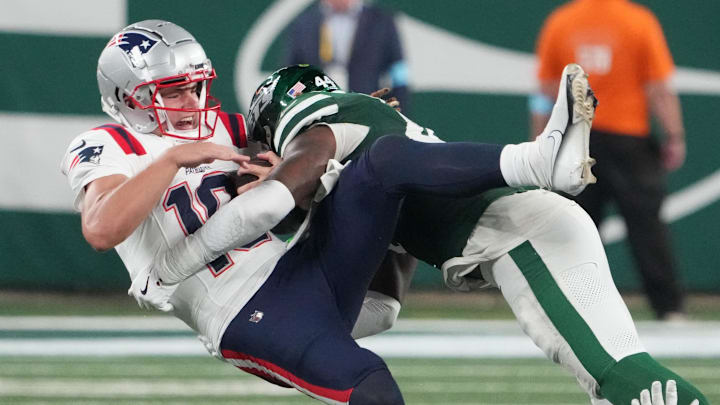 Sep 19, 2024; East Rutherford, New Jersey, USA; New England Patriots quarterback Drake Maye (10)  gets sacked hard by New York Jets linebacker Jamien Sherwood (44) in the 4th quarter at MetLife Stadium. Mandatory Credit: Robert Deutsch-Imagn Images