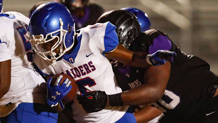 McGavock's Markellus Bass runs for yardage as he's hit by Cane Ridge defender during their game against Cane Ridge Thursday, Oct. 8, 2020, in Antioch, Tenn.
