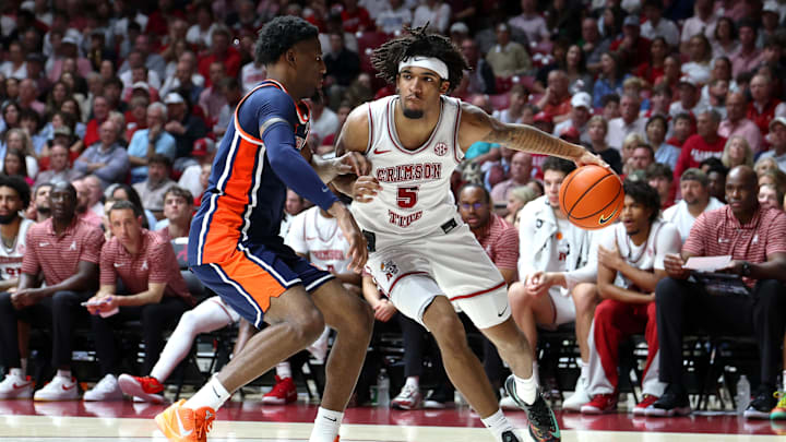Mar 7, 2026; Tuscaloosa, Alabama, USA; Alabama Crimson Tide forward Amari Allen (5) dribbles against Auburn Tigers guard Kevin Overton (1) during the second half at Coleman Coliseum. Mandatory Credit: David Leong-Imagn Images