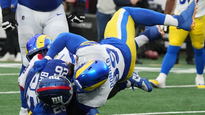 East Rutherford, NJ December 31, 2023 -- Saquon Barkley of the Giants is tackled by Aaron Donald of the Rams in the second half. The Los Angeles Rams edged the New York Giants 26-25 on December 31, 2023 at MetLife Stadium in East Rutherford, NJ. East Rutherford, NJ December 31, 2023 -- Saquon Barkley of the Giants is tackled by Aaron Donald of the Rams in the second half. The Los Angeles Rams edged the New York Giants 26-25 on December 31, 2023 at MetLife Stadium in East Rutherford, NJ.