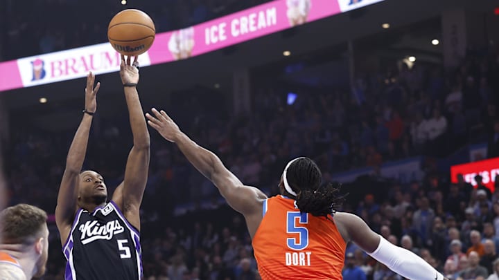 Feb 1, 2025; Oklahoma City, Oklahoma, USA; Sacramento Kings guard De'Aaron Fox (5) shoots as Oklahoma City Thunder guard Luguentz Dort (5) defends during the first quarter at Paycom Center. Feb 1, 2025; Oklahoma City, Oklahoma, USA; Sacramento Kings guard De'Aaron Fox (5) shoots as Oklahoma City Thunder guard Luguentz Dort (5) defends during the first quarter at Paycom Center.