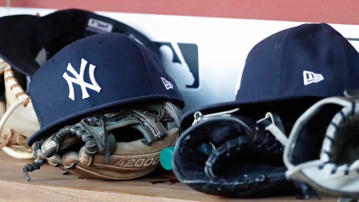 Jun 18, 2018; Washington, DC, USA; New York Yankees players caps and gloves rest in the dugout against the Washington Nationals at Nationals Park. Mandatory Credit: Geoff Burke-Imagn Images
