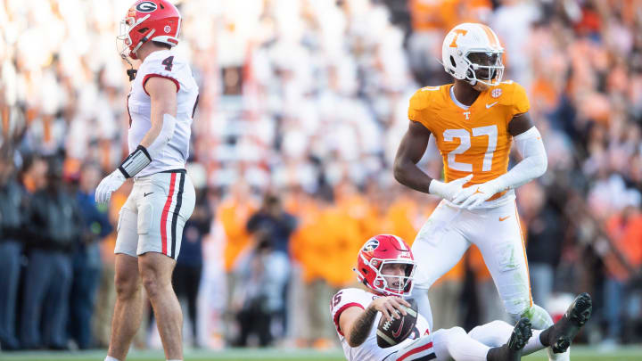Georgia quarterback Carson Beck (15) is seen on the ground in front of Tennessee defensive lineman James Pearce Jr. (27) during a football game between Tennessee and Georgia at Neyland Stadium in Knoxville, Tenn., on Saturday, Nov. 18, 2023.