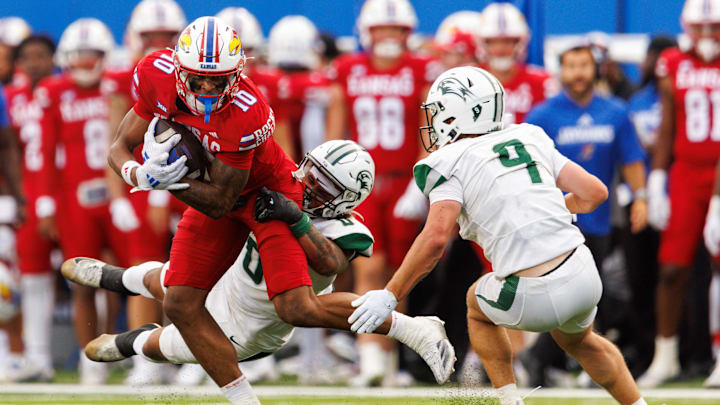 Aug 29, 2025; Lawrence, Kansas, USA. Kansas Jayhawks wide receiver Levi Wentz (10) is hit by Wagner Seahawks linebacker Armani Itote (0) during the first half at David Booth Kansas Memorial Stadium. Mandatory Credit: William Purnell-Imagn Images Aug 29, 2025; Lawrence, Kansas, USA. Kansas Jayhawks wide receiver Levi Wentz (10) is hit by Wagner Seahawks linebacker Armani Itote (0) during the first half at David Booth Kansas Memorial Stadium. Mandatory Credit: William Purnell-Imagn Images