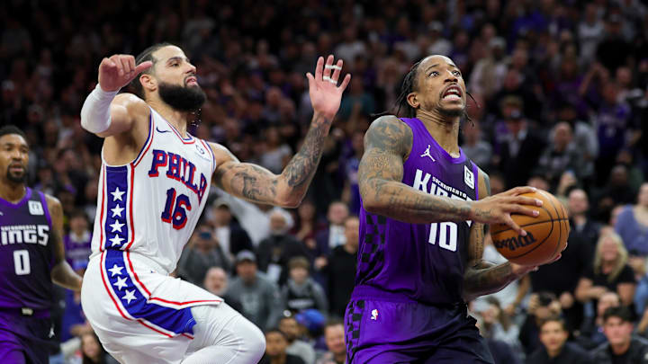 Jan 1, 2025; Sacramento, California, USA; Sacramento Kings forward DeMar DeRozan (10) drives to the basket against Philadelphia 76ers forward Caleb Martin (16) during the fourth quarter at Golden 1 Center. Mandatory Credit: Sergio Estrada-Imagn Images