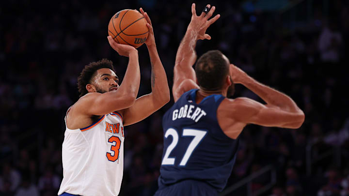 Oct 13, 2024; New York, New York, USA; New York Knicks center Karl-Anthony Towns (32) shoots the ball asMinnesota Timberwolves center Rudy Gobert (27) defends during the first half at Madison Square Garden. Mandatory Credit: Vincent Carchietta-Imagn Images