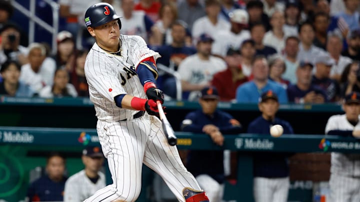 Mar 21, 2023; Miami, Florida, USA; Japan first baseman Kazuma Okamoto (25) bats against the USA in the sixth inning at LoanDepot Park. Mandatory Credit: Rhona Wise-Imagn Images