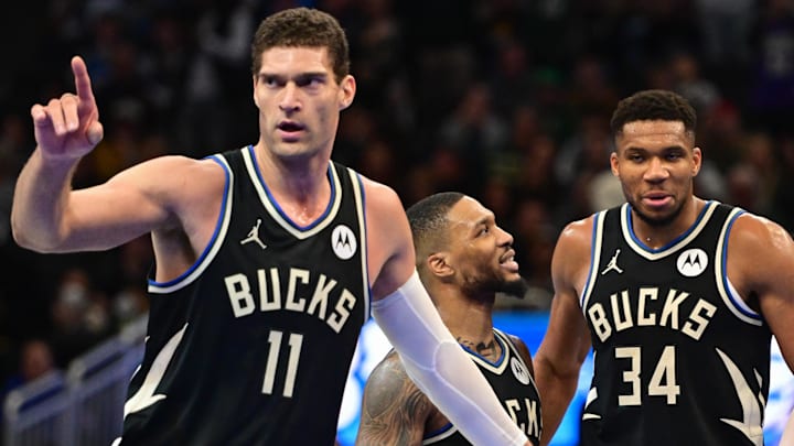 Nov 22, 2024; Milwaukee, Wisconsin, USA; Milwaukee Bucks center Brook Lopez (11), guard Damian Lillard (0) and forward Giannis Antetokounmpo (34) celebrate near the end of the game against the Indiana Pacers at Fiserv Forum. Mandatory Credit: Benny Sieu-Imagn Images