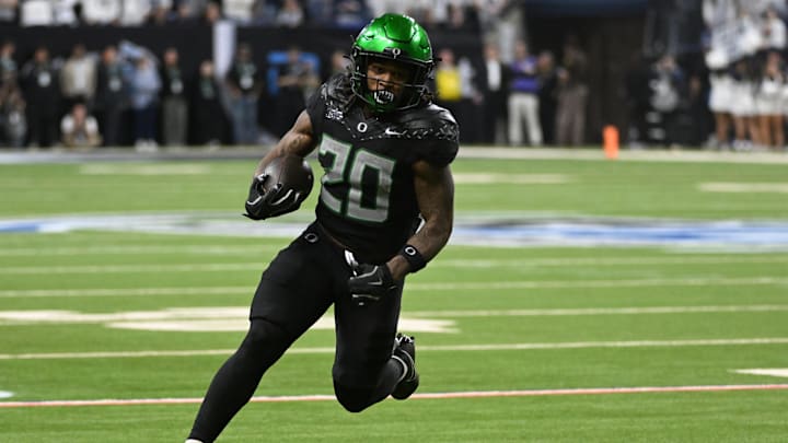 Dec 7, 2024; Indianapolis, IN, USA; Oregon Ducks running back Jordan James (20) runs for a gain against the Penn State Nittany Lions during the fourth quarter in the 2024 Big Ten Championship game at Lucas Oil Stadium.