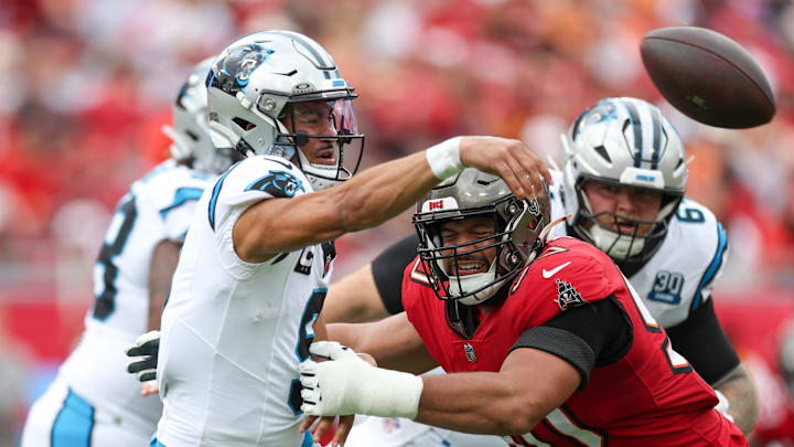 Dec 29, 2024; Tampa, Florida, USA; Carolina Panthers quarterback Bryce Young (9) is pressured by Tampa Bay Buccaneers defensive tackle Vita Vea (50) in the second quarter at Raymond James Stadium. Mandatory Credit: Nathan Ray Seebeck-Imagn Images