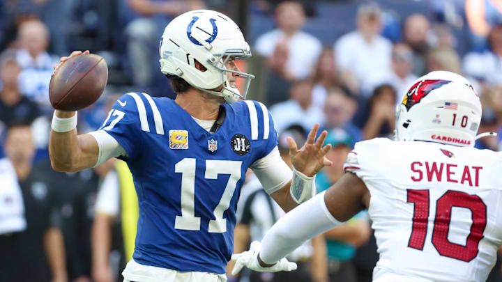 Indianapolis Colts quarterback Daniel Jones (17) passes the ball under pressure from Arizona Cardinals outside linebacker Josh Sweat (10) during the second quarter of the game at Lucas Oil Stadium.