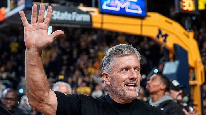 Michigan football head coach Kyle Whittingham waves at the crowd as he is being introduced on the floor during the first half between Michigan and USC at Crisler Center in Ann Arbor on Friday, Jan. 2, 2026. Michigan football head coach Kyle Whittingham waves at the crowd as he is being introduced on the floor during the first half between Michigan and USC at Crisler Center in Ann Arbor on Friday, Jan. 2, 2026.