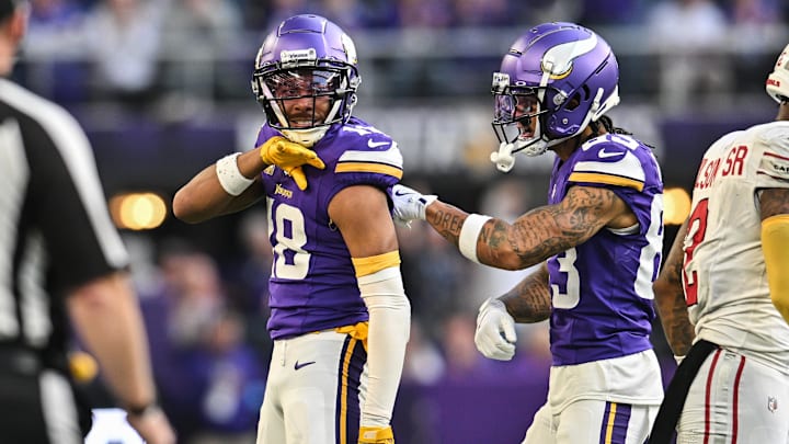 Dec 1, 2024; Minneapolis, Minnesota, USA; Minnesota Vikings wide receiver Justin Jefferson (18) reacts with wide receiver Jalen Nailor (83) during the fourth quarter against the Arizona Cardinals at U.S. Bank Stadium. Mandatory Credit: Jeffrey Becker-Imagn Images
