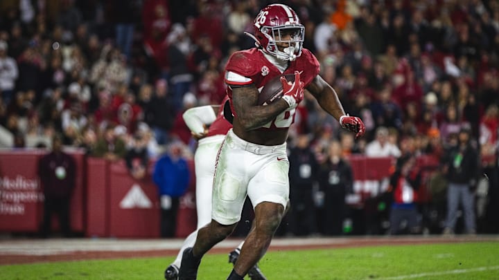 Nov 30, 2024; Tuscaloosa, Alabama, USA; Alabama Crimson Tide running back Jam Miller (26) runs the ball against the Auburn Tigers during the third quarter at Bryant-Denny Stadium. Mandatory Credit: Will McLelland-Imagn Images