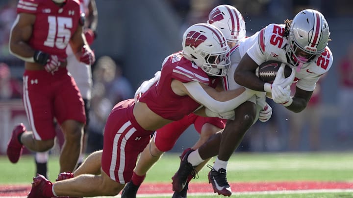 Oct 18, 2025; Madison, Wisconsin, USA; Wisconsin Badgers linebacker Christian Alliegro (0) tackles Ohio State Buckeyes running back Bo Jackson (25) in the first quarter at Camp Randall Stadium. Mandatory Credit: Jeff Hanisch-Imagn Images Oct 18, 2025; Madison, Wisconsin, USA; Wisconsin Badgers linebacker Christian Alliegro (0) tackles Ohio State Buckeyes running back Bo Jackson (25) in the first quarter at Camp Randall Stadium. Mandatory Credit: Jeff Hanisch-Imagn Images
