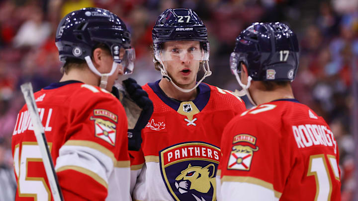 Apr 9, 2024; Sunrise, Florida, USA; Florida Panthers center Eetu Luostarinen (27) talks to center Anton Lundell (15) and center Evan Rodrigues (17) during the first period at Amerant Bank Arena. Mandatory Credit: Sam Navarro-Imagn Images