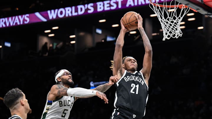 Dec 14, 2025; Brooklyn, New York, USA; Brooklyn Nets forward/center Noah Clowney (21) shoots the ball defended by Milwaukee Bucks guard Gary Trent Jr. (5) during the second half at Barclays Center. Mandatory Credit: John Jones-Imagn Images