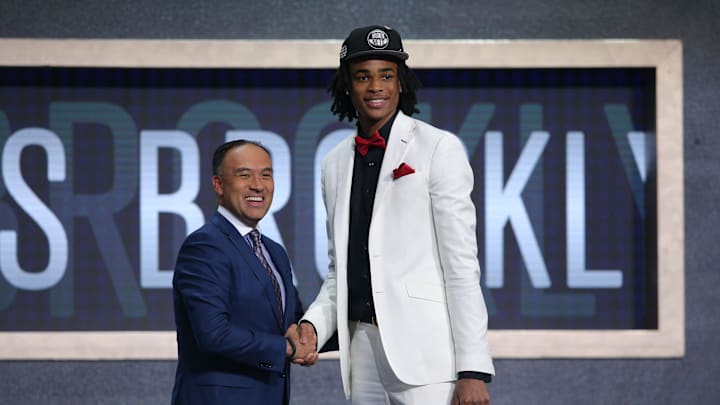Jun 20, 2019; Brooklyn, NY, USA; Nicholas Claxton (Georgia) greets NBA deputy commissioner Mark Tatum after being selected as the number thirty-one overall pick to the Brooklyn Nets during the second round of the 2019 NBA Draft at Barclays Center. Mandatory Credit: Brad Penner-Imagn Images