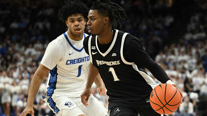 Feb 28, 2026; Omaha, Nebraska, USA;  Providence Friars guard Jason Edwards (1) dribbles around Creighton Bluejays guard Austin Swartz (1) during the first half at CHI Health Center Omaha. Mandatory Credit: Steven Branscombe-Imagn Images