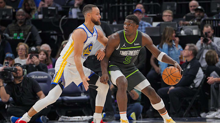 Mar 24, 2024; Minneapolis, Minnesota, USA; Golden State Warriors guard Stephen Curry (30) defends Minnesota Timberwolves guard Anthony Edwards (5) in the third quarter at Target Center. Mandatory Credit: Brad Rempel-Imagn Images
