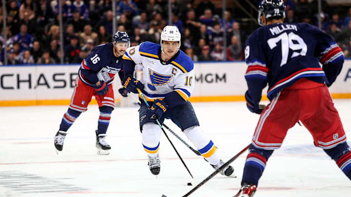 Mar 9, 2024; New York, New York, USA; St. Louis Blues center Brayden Schenn (10) skates with the puck in front of New York Rangers defenseman K'Andre Miller (79) during the third period at Madison Square Garden. Mandatory Credit: Danny Wild-Imagn Images