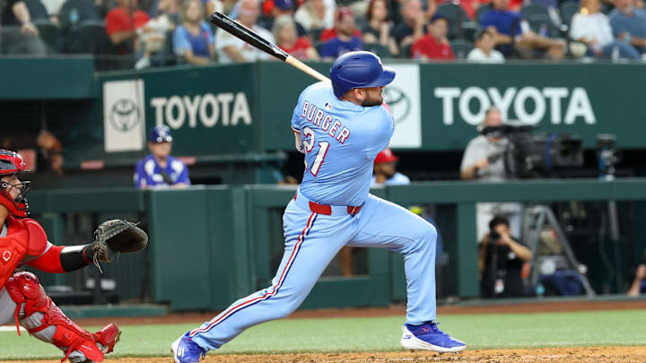 Jun 1, 2025; Arlington, Texas, USA; Texas Rangers designated hitter Jake Burger (21) hits an rbi double during the eighth inning against the St. Louis Cardinals at Globe Life Field. 