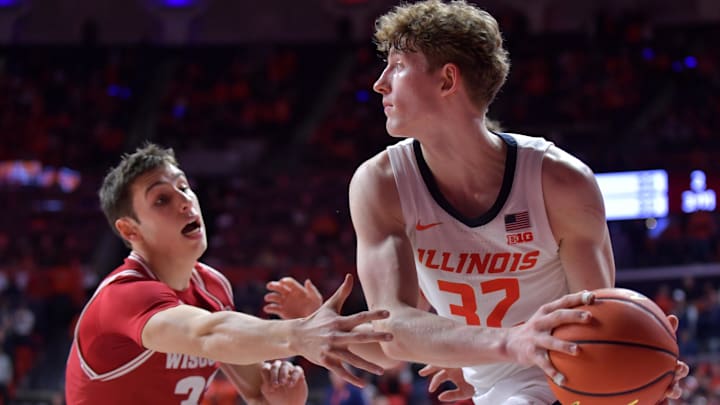 Dec 10, 2024; Champaign, Illinois, USA;  Illinois Fighting Illini guard Kasparas Jakucionis (32) looks to pass as Wisconsin Badgers guard Jack Janicki (33) pressures him during the second half at State Farm Center. Mandatory Credit: Ron Johnson-Imagn Images