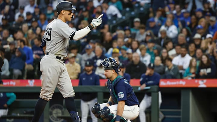 May 30, 2023; Seattle, Washington, USA; New York Yankees center fielder Aaron Judge (99) celebrates after hitting a solo-home run against the Seattle Mariners during the seventh inning at T-Mobile Park. Seattle Mariners catcher Cal Raleigh (29) kneels at right. Mandatory Credit: Joe Nicholson-Imagn Images