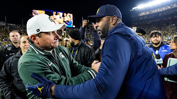 Michigan State head coach Jonathan Smith, left, shakes hands with head coach Sherrone Moore after 24-17 loss at Michigan Stadium in Ann Arbor on Saturday, Oct. 26, 2024.