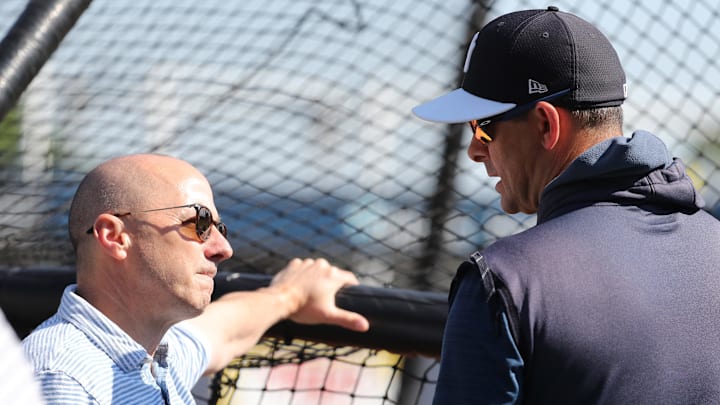 Mar 23, 2019; Tampa, FL, USA; New York Yankees general manager Brian Cashman (left) and manager Aaron Boone (17)  talk prior to the game against the Toronto Blue Jays at George M. Steinbrenner Field. Mandatory Credit: Kim Klement-Imagn Images