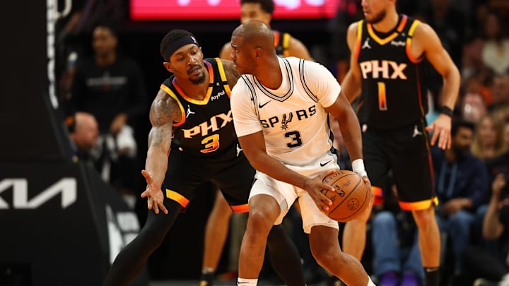 Dec 3, 2024; Phoenix, Arizona, USA; San Antonio Spurs guard Chris Paul (right) controls the ball against Phoenix Suns guard Bradley Beal in the second half of an NBA Cup game at Footprint Center. Mandatory Credit: Mark J. Rebilas-Imagn Images Dec 3, 2024; Phoenix, Arizona, USA; San Antonio Spurs guard Chris Paul (right) controls the ball against Phoenix Suns guard Bradley Beal in the second half of an NBA Cup game at Footprint Center. Mandatory Credit: Mark J. Rebilas-Imagn Images