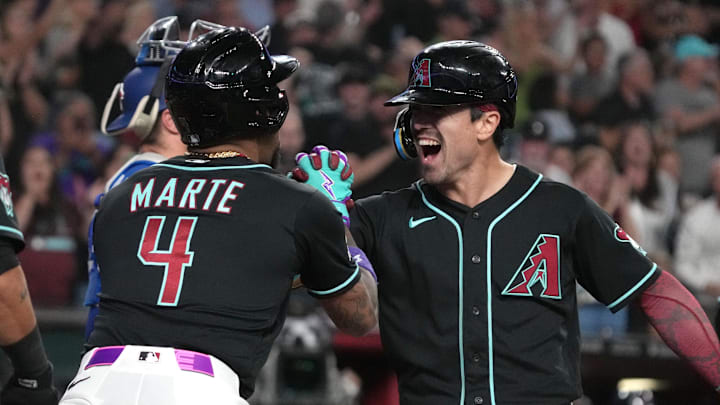 Apr 18, 2026; Phoenix, Arizona, USA; Arizona Diamondbacks right fielder Corbin Carroll (7) celebrates with second baseman Ketel Marte (4) after hitting a grand slam against the Toronto Blue Jays in the eighth inning at Chase Field. Mandatory Credit: Rick Scuteri-Imagn Images